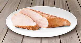 A slice of cooked meat is presented on a white plate.