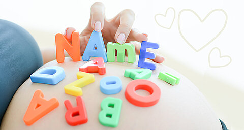 A hand places colorful letters on a surface, forming the word "NAME."