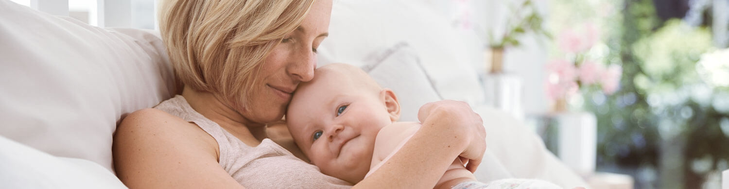 A woman is holding a baby.
