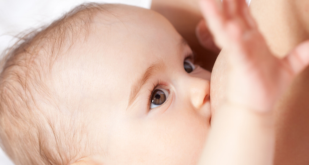 A close-up of a baby's face, with one eye visible, looking towards the camera.