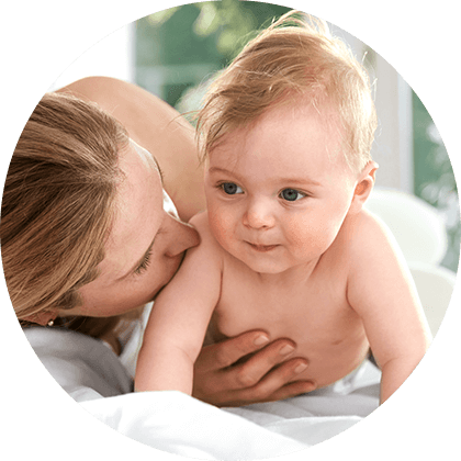 A woman is holding a baby.