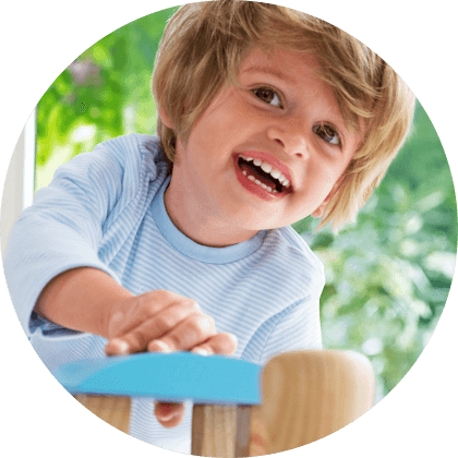 A child with blonde hair is holding onto a blue object.