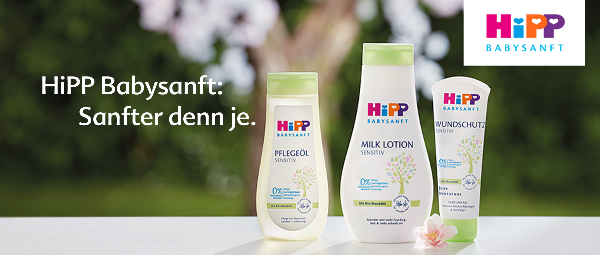 Three baby care products from the brand 'HiPP Babysanft' are displayed against a blurred natural background.