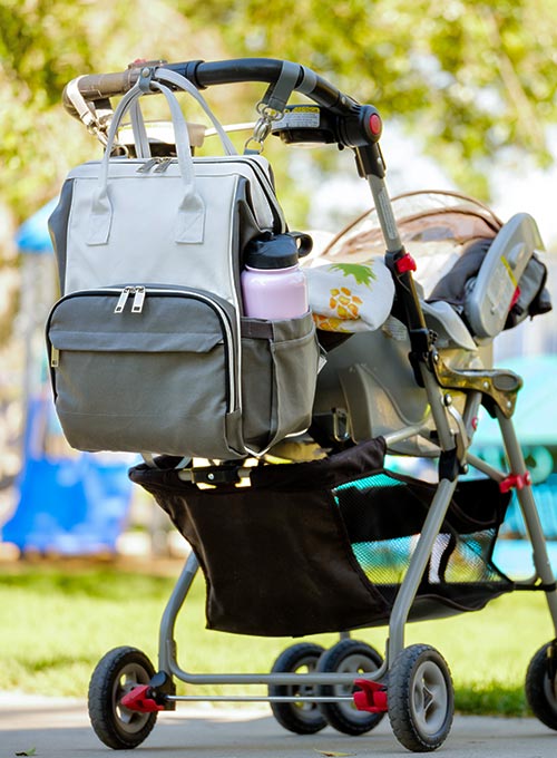 Stroller with attached bag and water bottle.