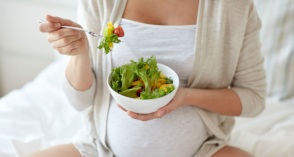 A person is eating a salad.
