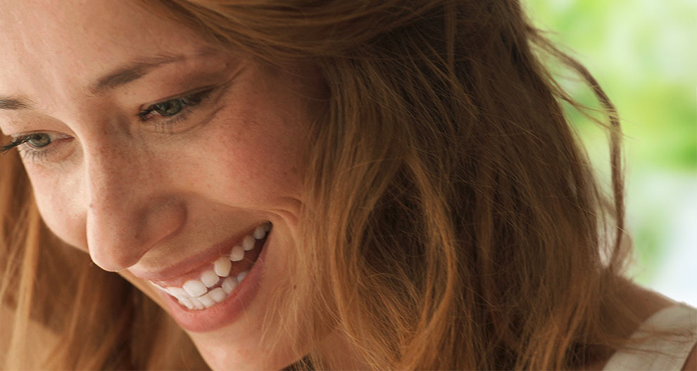 Close-up of a smiling woman.