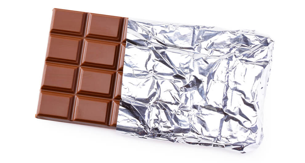 Chocolate bar with silver foil wrapping.